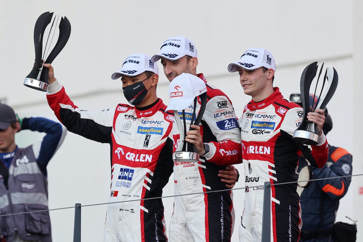 (L to R) Yifei Ye, Robert Kubica, Louis Deletraz celebrate an ELMS podium finish.