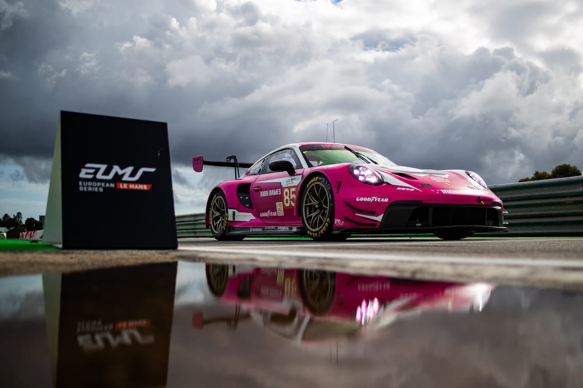 An Iron Dames Porsche 911 LMGT3.R drives by a European Le Mans Series logo bollard